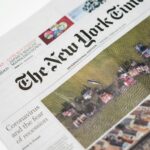 Detailed shot of New York Times newspaper featuring coronavirus and recession headline.