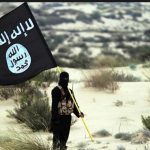 isis member posing with the group's flag